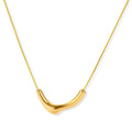 Minimalist gold-plated curved pendant necklace on delicate chain against cream background, showing adjustable length
