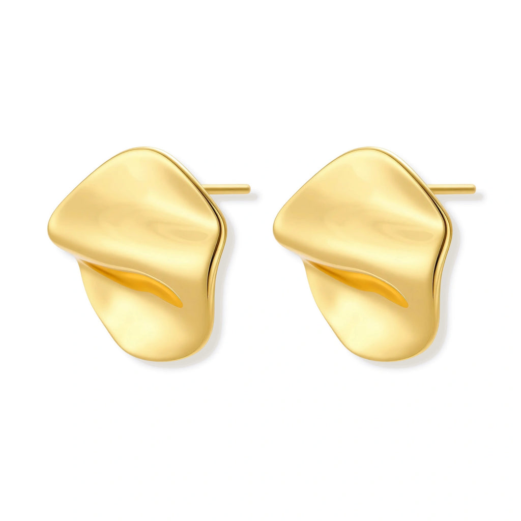 Close-up of organic gold-plated sterling silver stud earrings with flowing sculptural design and curved cut-outs