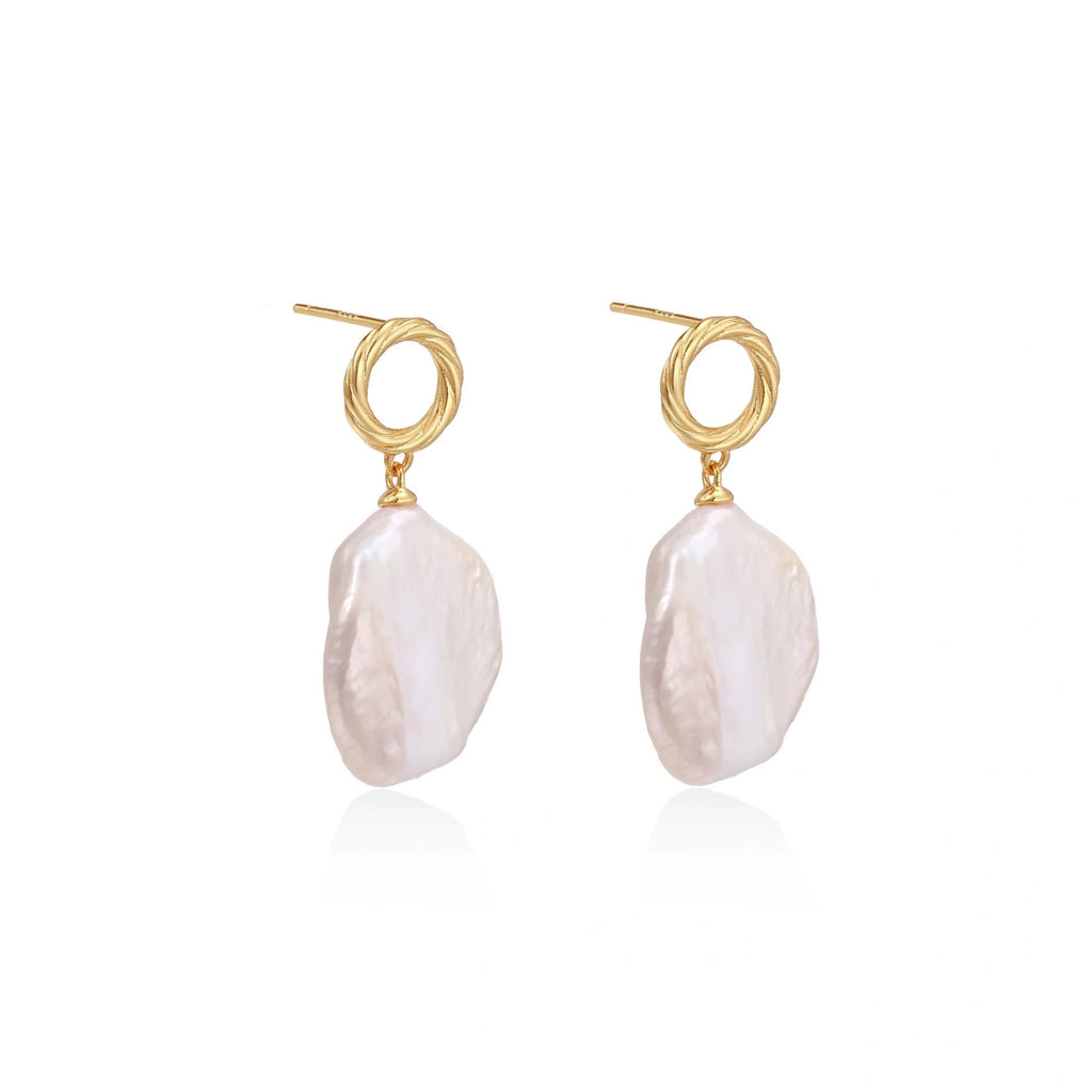 18K gold vermeil twisted circle studs with organic white baroque pearl drops on cream background
