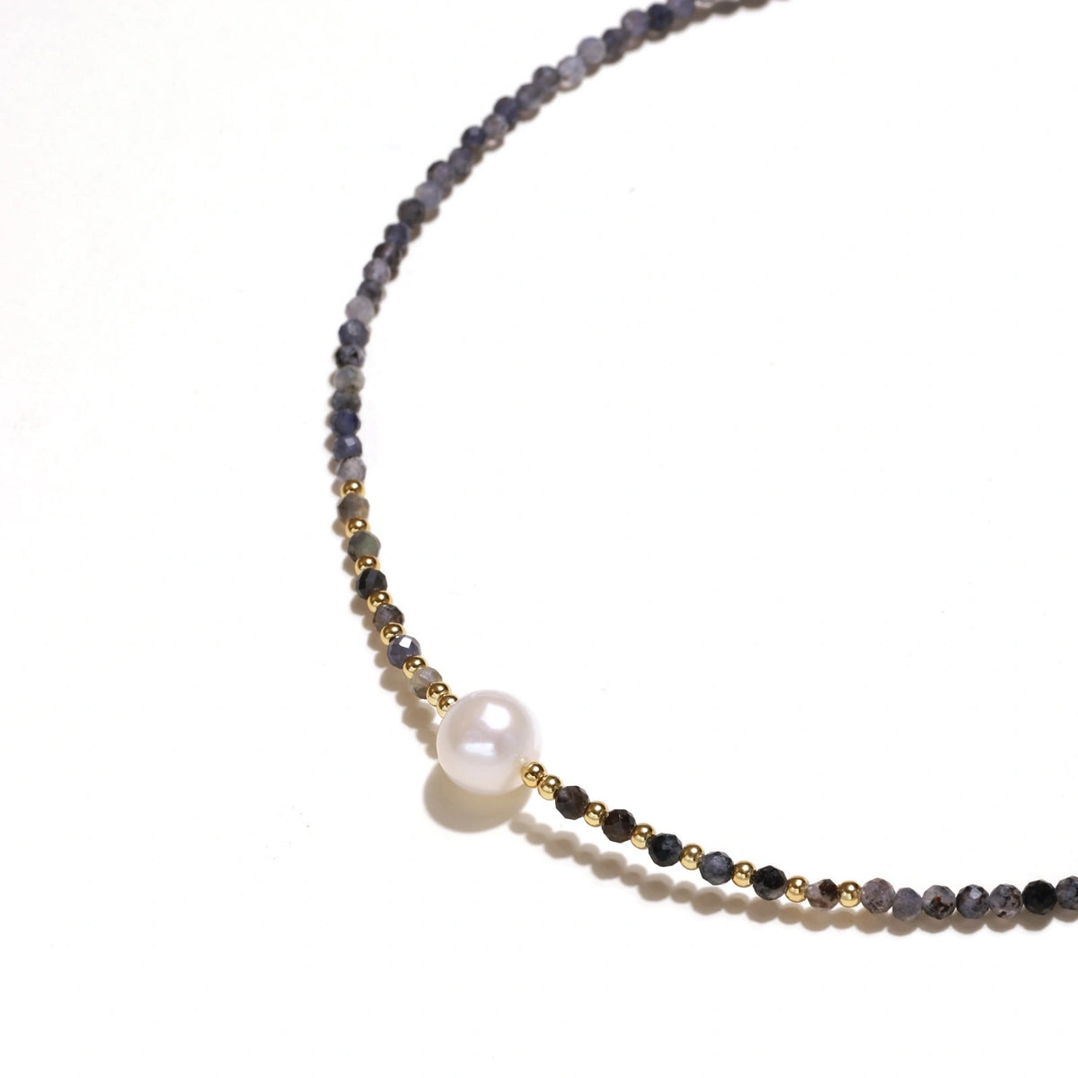 Dainty necklace with faceted purple iolite beads, gold vermeil accents, and central pink-white freshwater pearl.