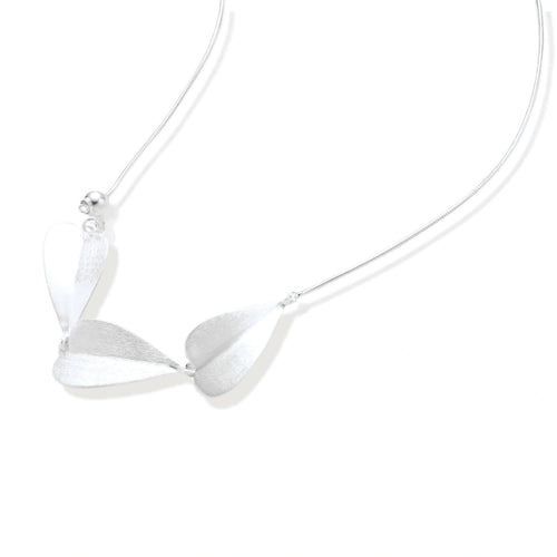 Minimalist sterling silver necklace with three brushed leaf-shaped pendants on delicate chain against white background