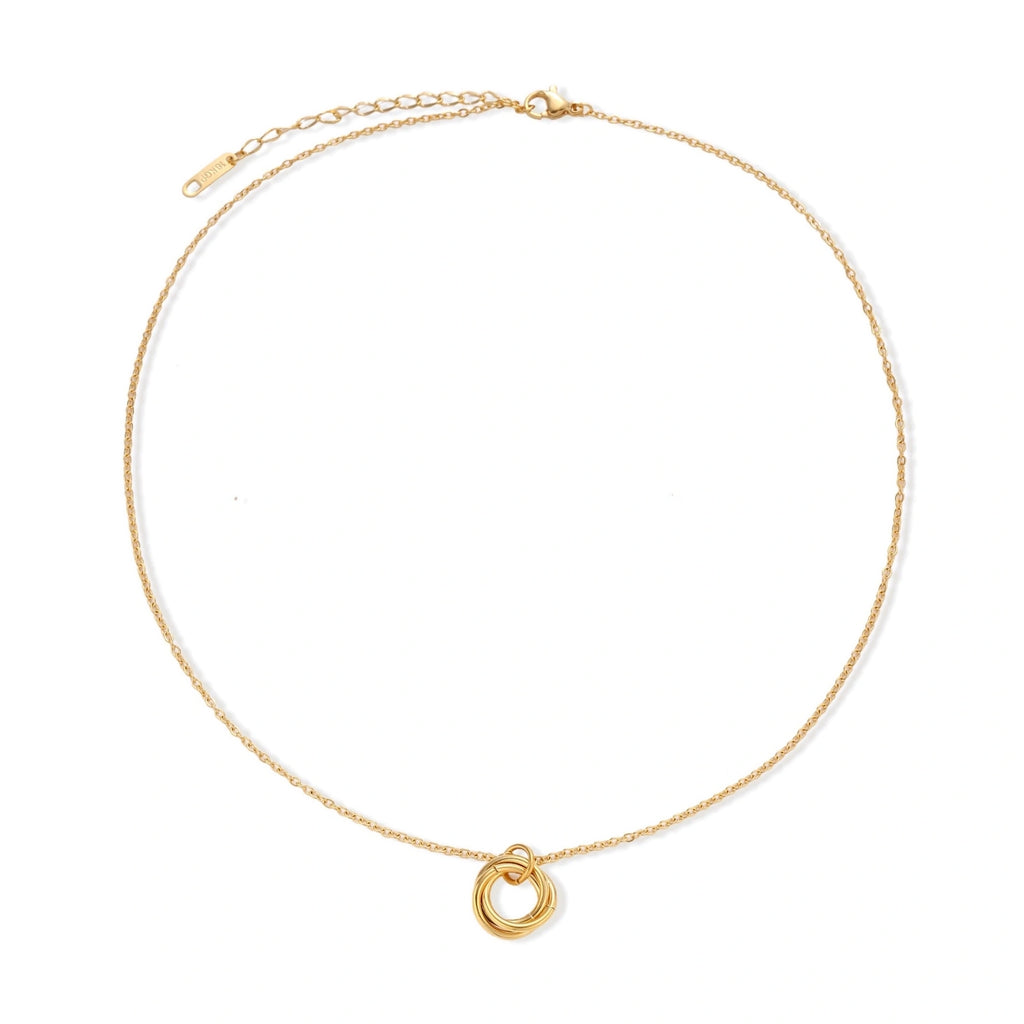 Delicate gold-plated necklace with three interlocking circle rings forming a minimalist knot pendant on cream background