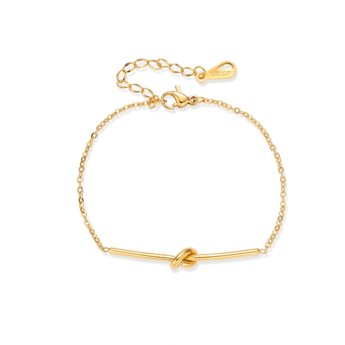 Delicate gold chain bracelet with minimalist bar and centered knot detail on cream background