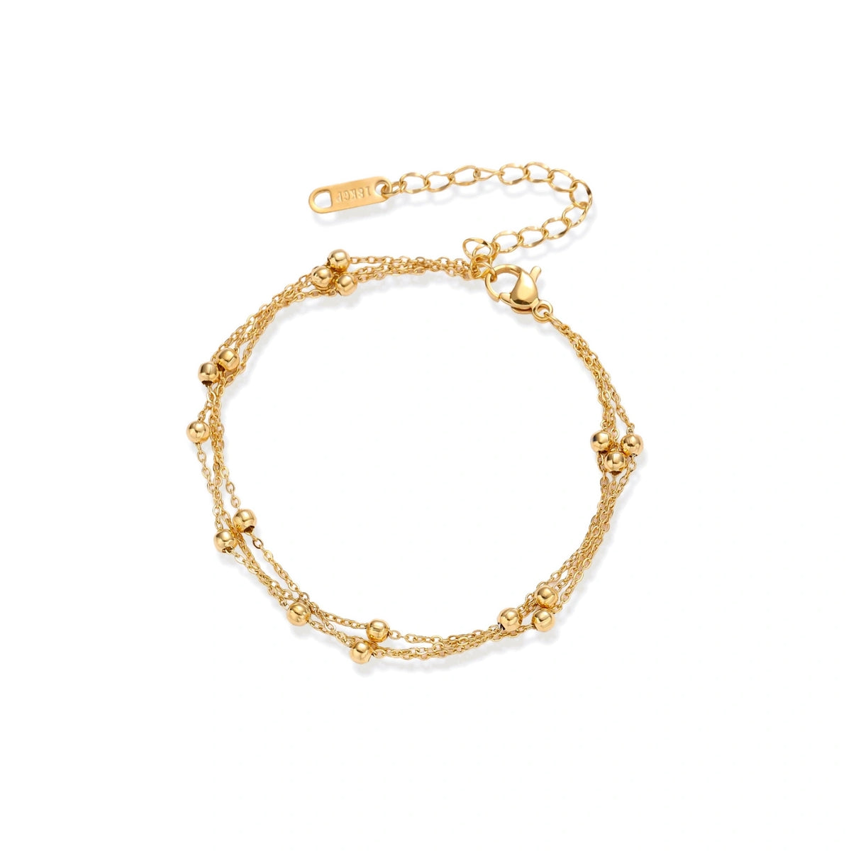 Three-strand gold-plated bracelet with clustered ball beads and adjustable clasp on cream background