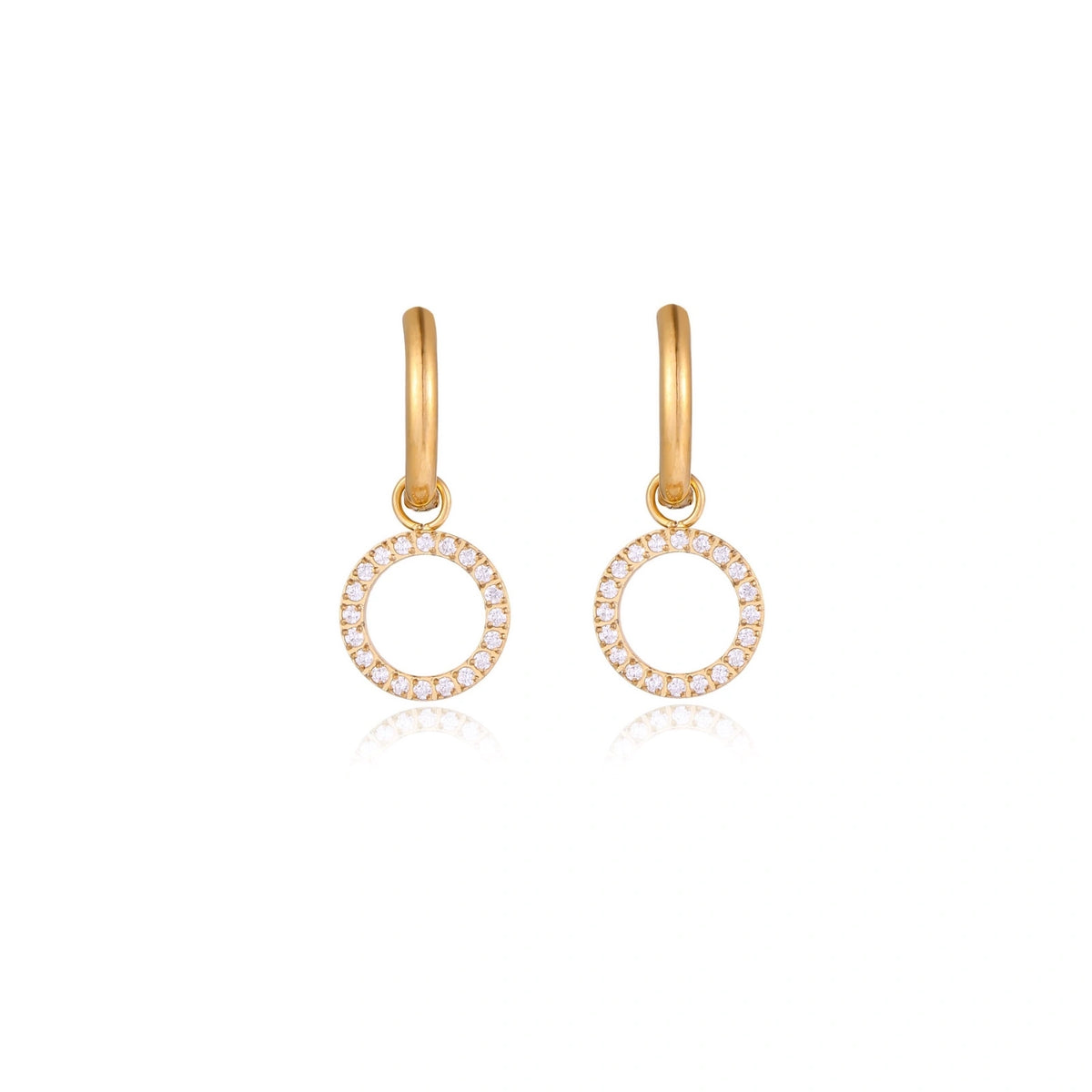 Gold-plated huggie hoop earrings with CZ-studded open circle charms on beige background