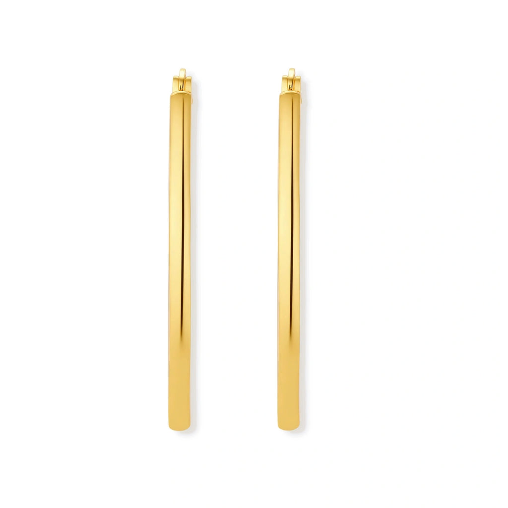 Set of geometric gold-plated sterling silver hoop earrings in oval and cushion shapes on cream background