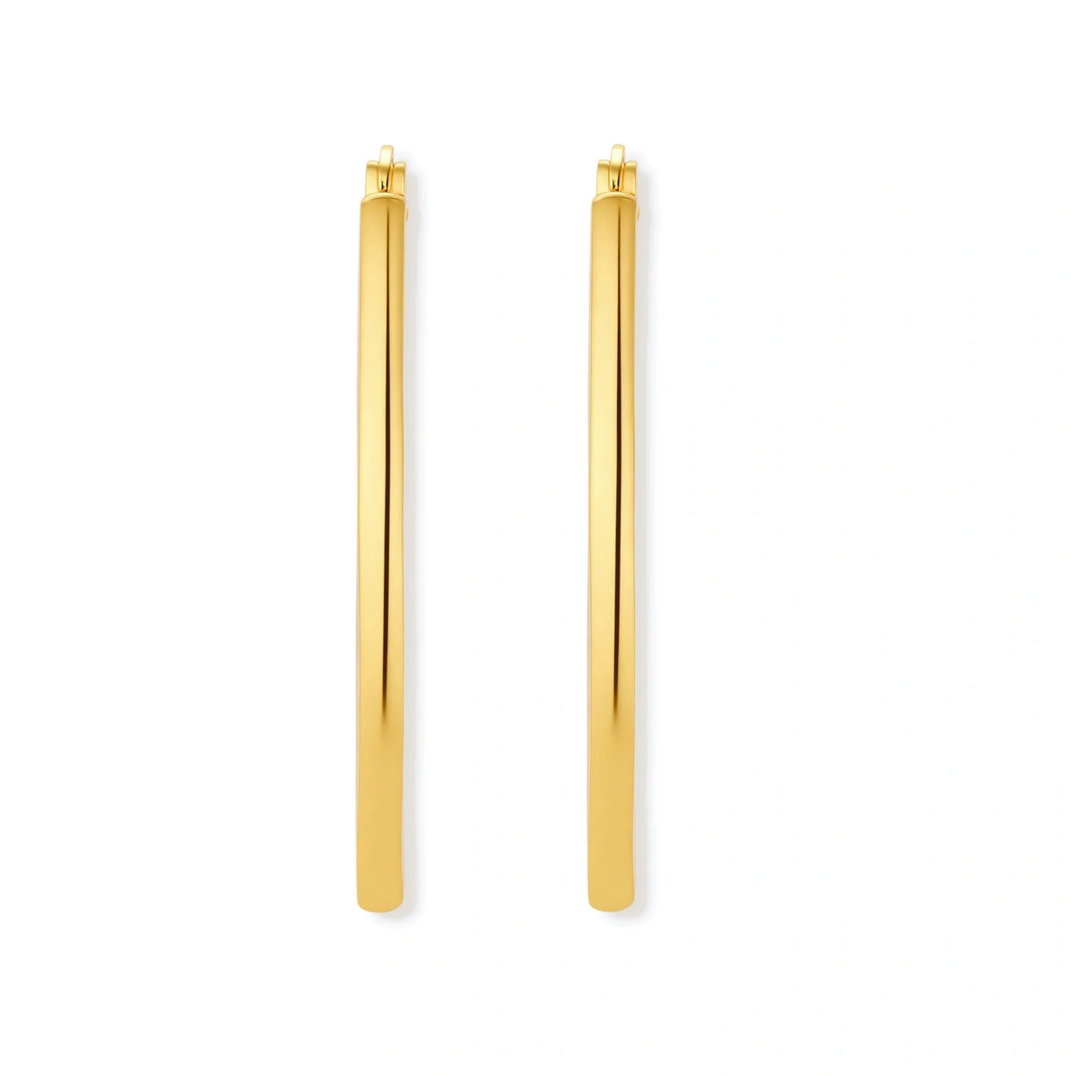 Set of geometric gold-plated sterling silver hoop earrings in oval and cushion shapes on cream background