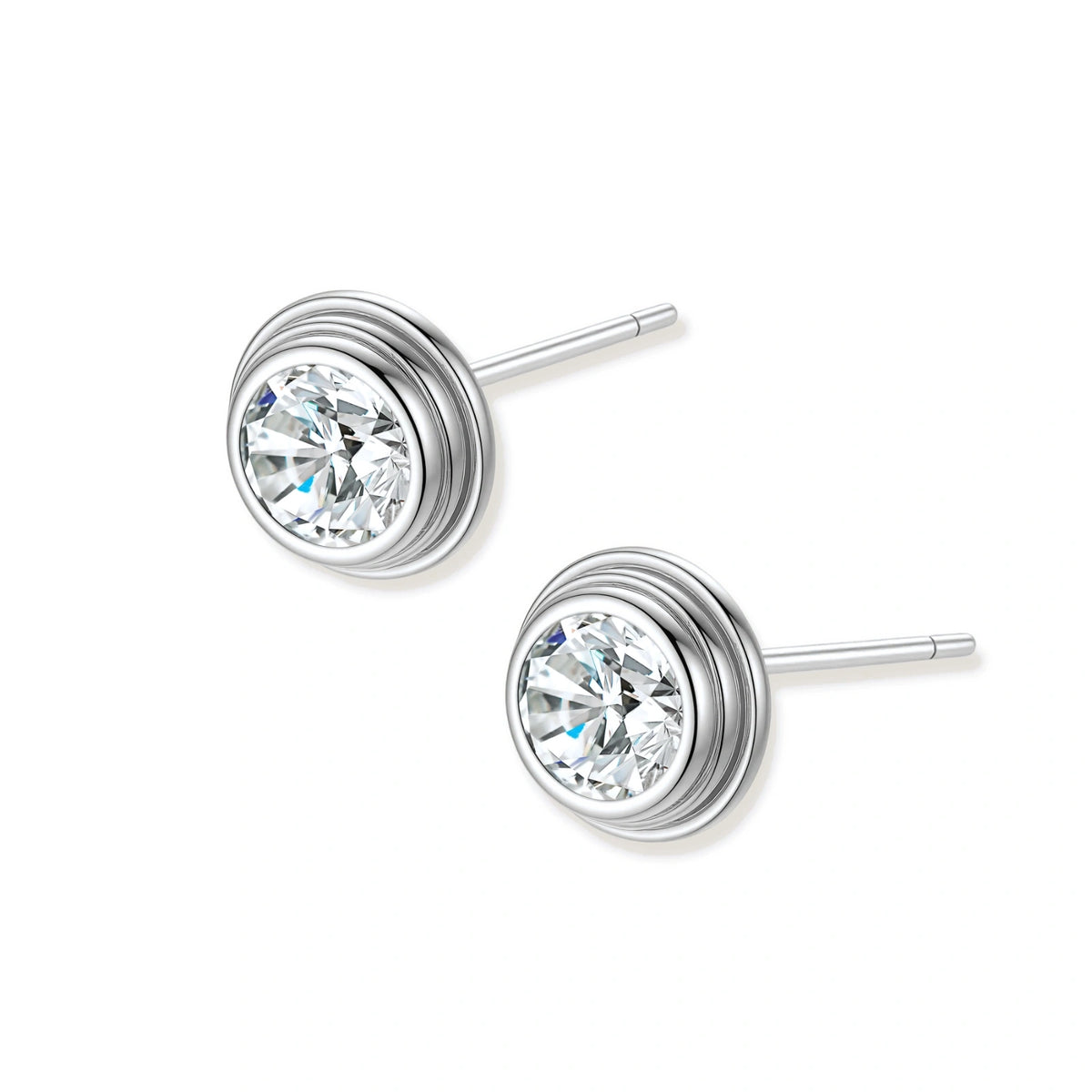 Close-up of sterling silver stud earrings featuring concentric circular frames with brilliant moissanite centers