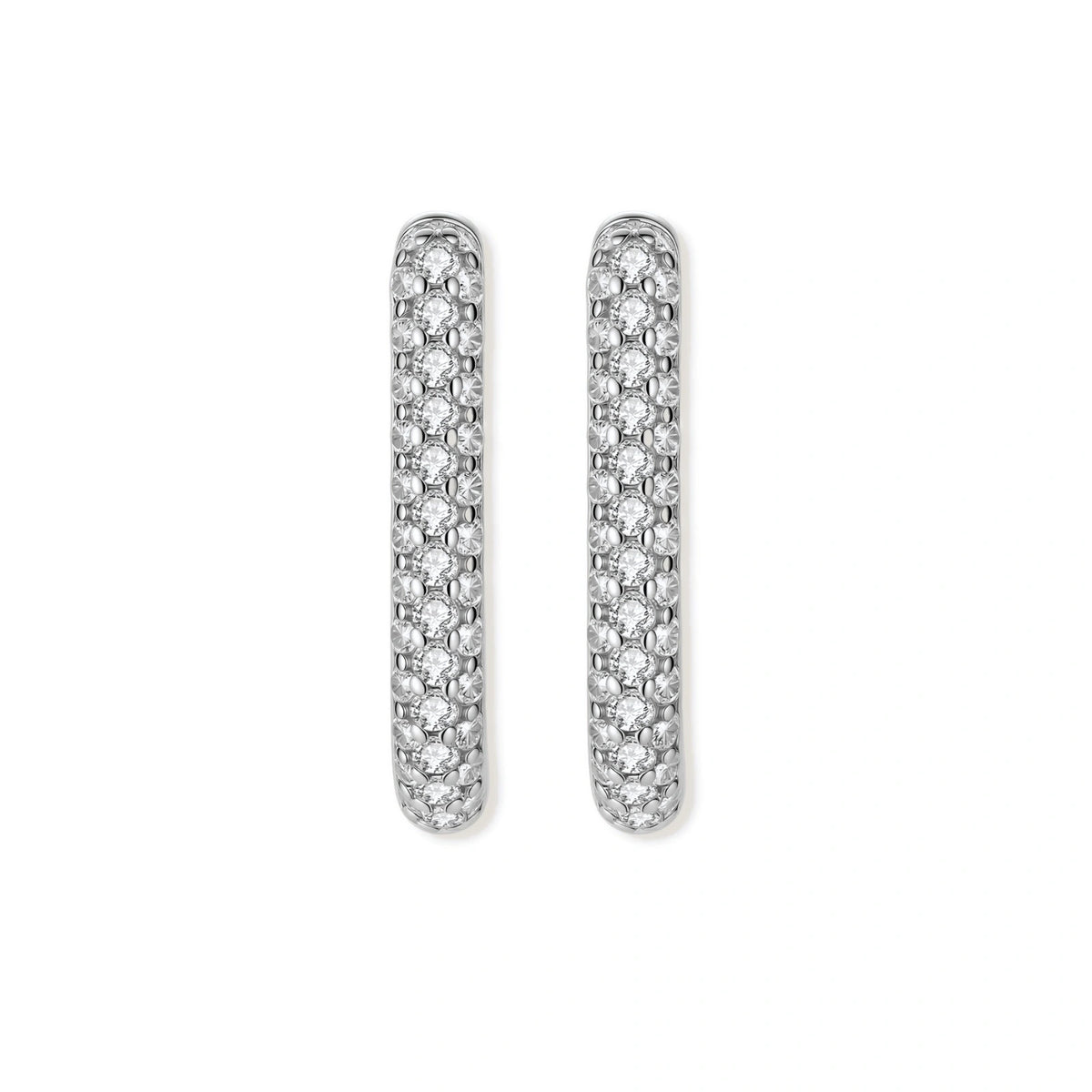 Close-up of platinum-plated sterling silver huggie hoops with pavé crystal setting on white background.