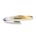 Polished two-tone bypass cuff bracelet in 18K gold plated and silver stainless steel with overlapping tapered ends.