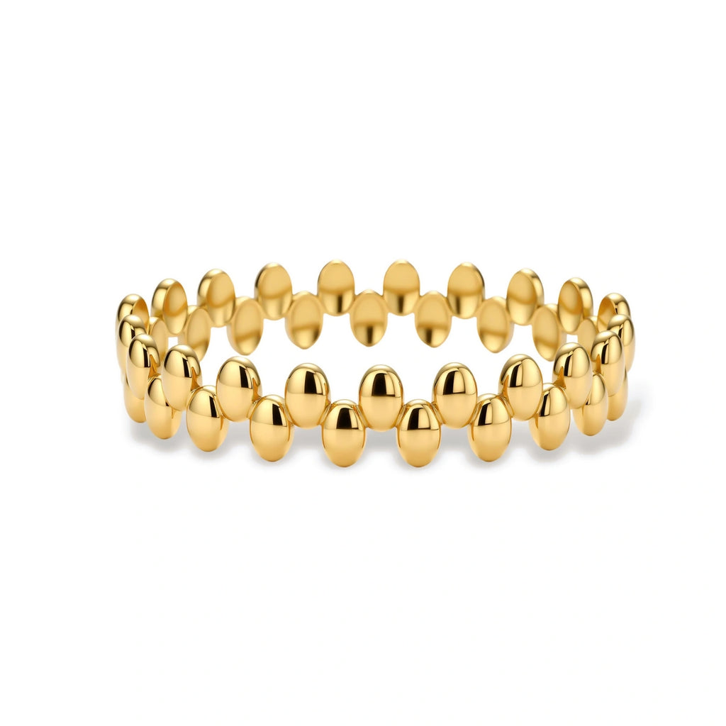 18K gold plated stainless steel bangle with dual rows of polished oval pebble beads on a cream background.